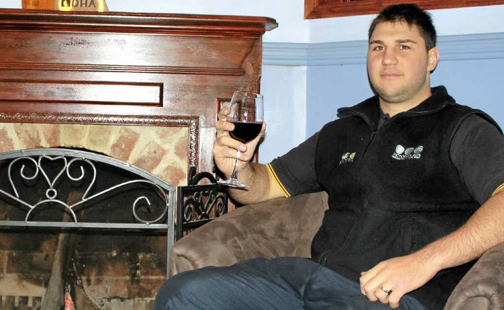Darren Pettiford avoids the winter weather by warming up by the Warwick Hotel’s wood fire with a glass of red wine.